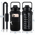 Black insulated water bottle with carrying strap, shown with dimension callouts and a phone inserted into the front pocket. The bottle has a black mesh sleeve, black lid, carry handle, and printed motivational text on the front.