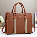 Brown striped tote handbag with matching leather handles, gold hardware, and detachable shoulder strap.