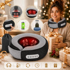 A gray and black neck and shoulder massage pillow with red LED light therapy is shown on a woman's neck in a cozy holiday setting. The image includes feature callout circles showing massage modes, a control panel close-up, a battery icon, and a suitcase icon indicating portability, along with a black drawstring bag and gift boxes.