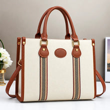 Cream and brown striped tote handbag with leather handles, gold hardware, and detachable shoulder strap.