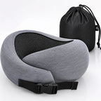 A gray and black travel neck pillow with an adjustable black strap, shown in front of a black drawstring storage bag on a white background.