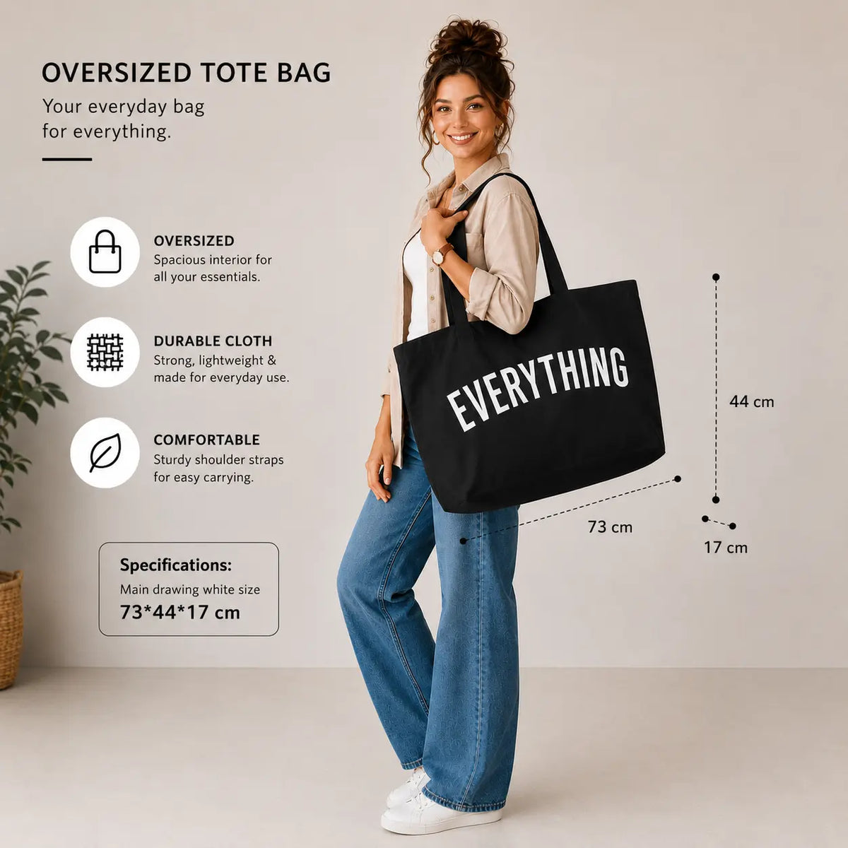 Black oversized Everything tote bag carried by a woman with 73 × 44 × 17 cm size specifications