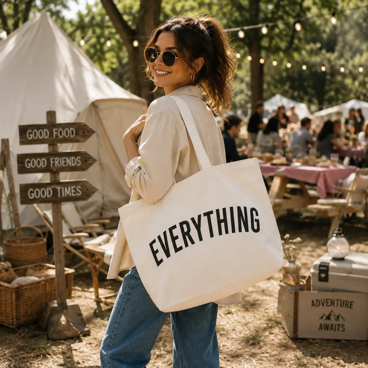 Off white Everything tote bag carried by a woman at an outdoor picnic event
