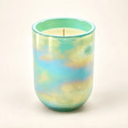 Pastel Glow scented wax candle in a pastel marbled glass vessel with mint green, pale yellow, and soft aqua blue tones.